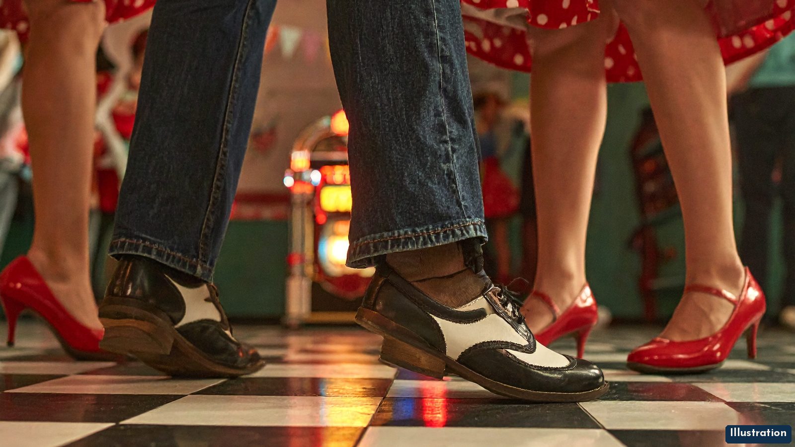 Illustration of dancers’ feet on a black-and-white checkerboard floor at a 1950s-style sock hop: two-tone wingtips, red heels and polka-dot skirts, with a glowing jukebox and pennants behind.