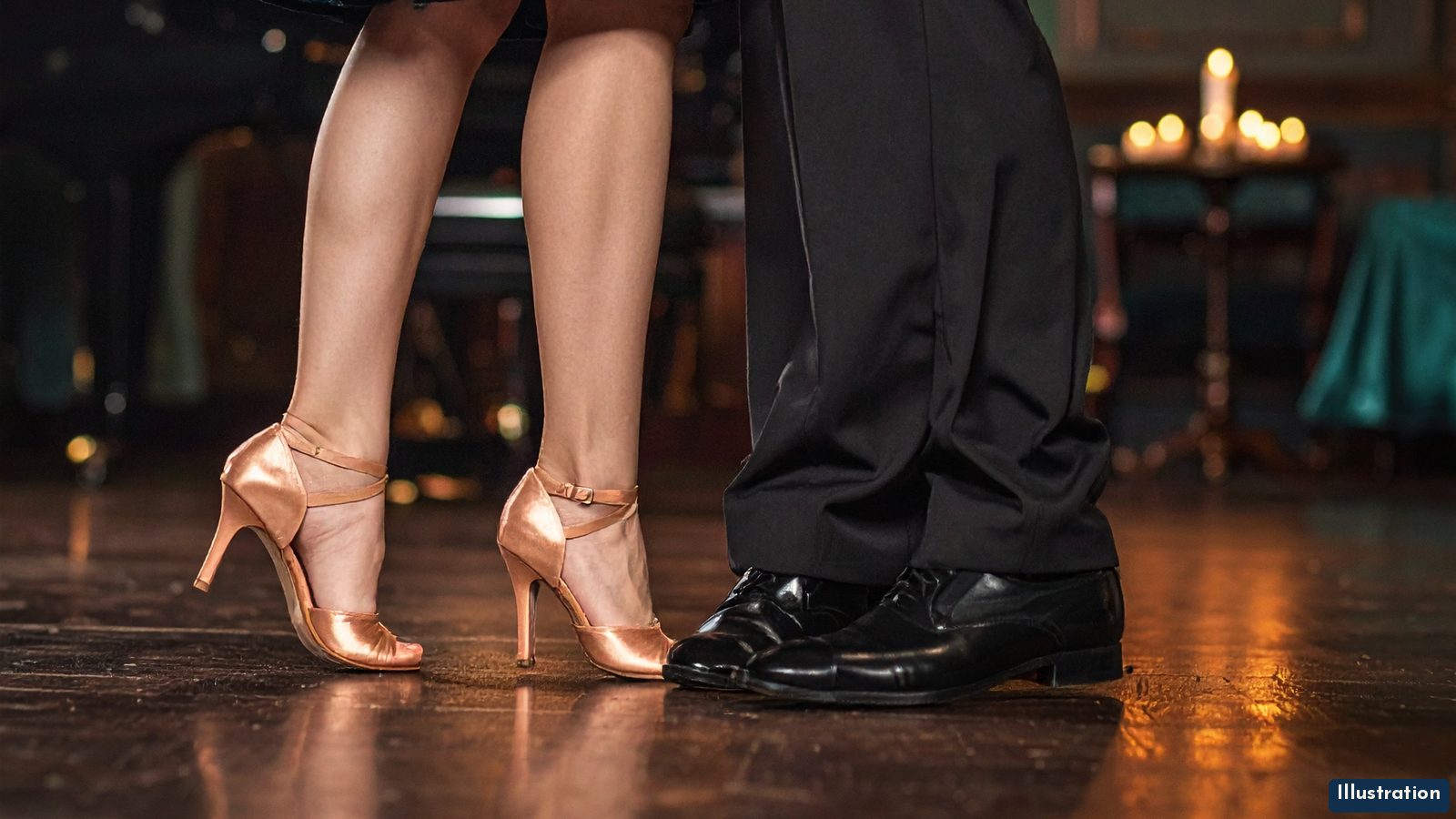 Illustration: a floor-level close-up of a dance couple's feet on a polished dark wood floor in an evening piano lounge. She wears a midnight-teal satin dress and nude ballroom heels; he wears black trousers and black dance shoes. A grand piano and candlelit tables glow out of focus behind them.